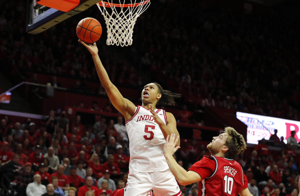 Indiana forward Malik Reneau (5) drives to the basket ahead of Rutgers guard Cam Spencer (10) during the first half of an NCAA college basketball game in Piscataway, N.J., Saturday, Dec. 3, 2022. (AP Photo/Noah K. Murray)