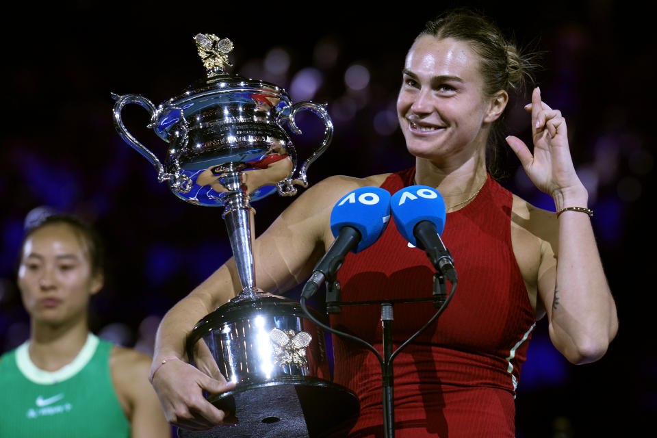 Aryna Sabalenka of Belarus holds the Daphne Akhurst Memorial Cup after defeating Zheng Qinwen of China in the women's singles final at the Australian Open tennis championships at Melbourne Park, Melbourne, Australia, Saturday, Jan. 27, 2024. (AP Photo/Andy Wong)