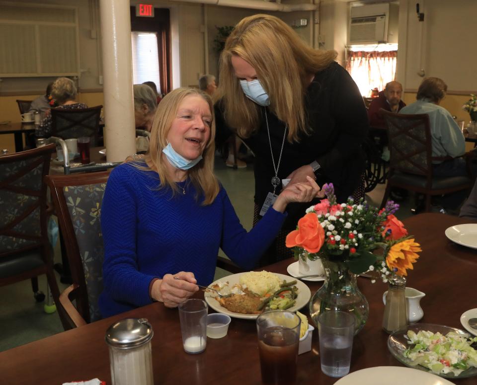 Vassar-Warner Senior Residence executive director Ericka Von Salews talks with resident, Barbara Lake, during lunch on November 16, 2021.