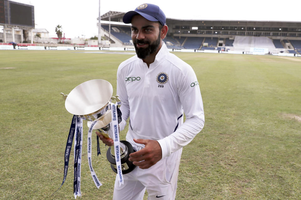 India's captain Virat Kohli walks with the series trophy after day four of the second Test cricket match against West Indies at Sabina Park cricket ground in Kingston, Jamaica Monday, Sept. 2, 2019. India won by 257 runs. (AP Photo/Ricardo Mazalan)