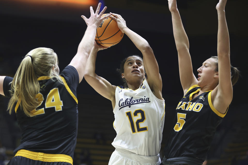 FILE - California forward Jadyn Bush (12) goes to the basket against Idaho guards Tiana Johnson (24) and Beyonce Bea (5) in the first half of an NCAA college basketball game Wednesday, Nov. 16, 2022, in Berkeley, Calif. Jadyn Bush is not only working on the court. She's also working toward her master’s degree and focusing her attention on helping find housing options for people coming back into communities from prison and others in marginalized populations. (AP Photo/Lachlan Cunningham, File)