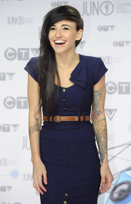 "Toes" singer Lights looks like a lady in a cute navy blue suit dress, with gold buttons, a vintage belt and stand-out shoulder detailing. Her awesome tattoos add some spunk to the whole look. THE CANADIAN PRESS/Sean Kilpatrick