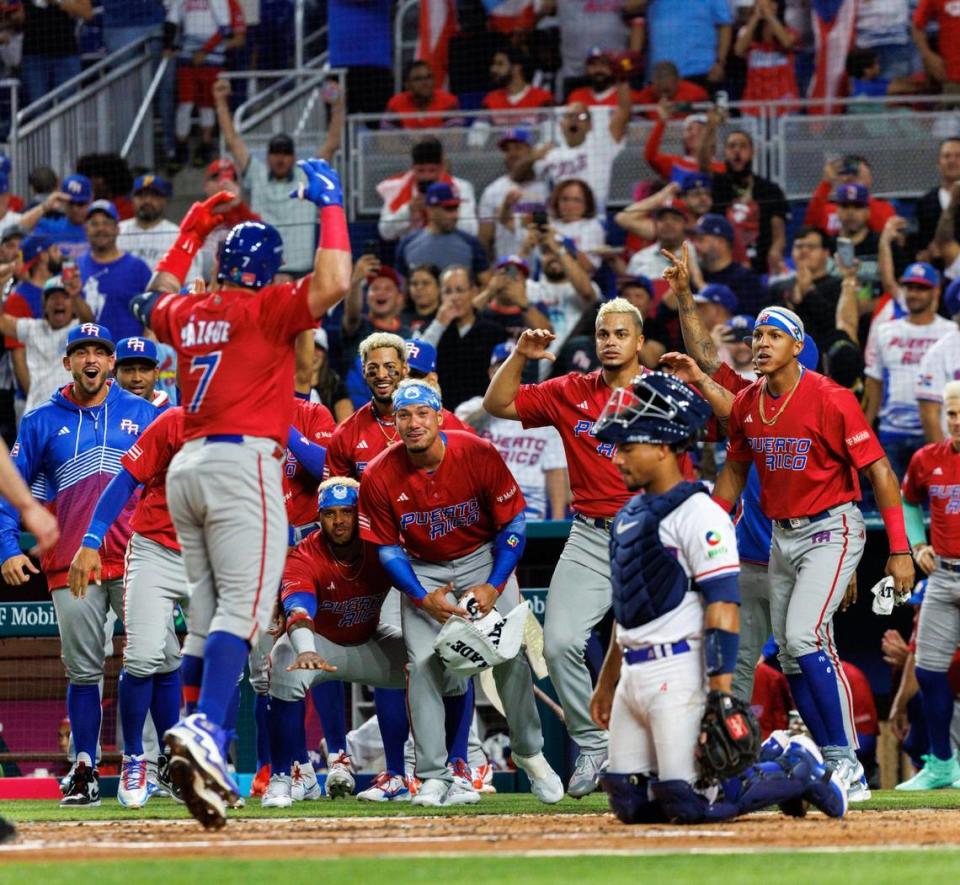 Puerto Rico designated hitter Christian Vazquez (7) celebrates with teammates after hitting on a solo home run during the third inning of a Pool D game against Dominican Republic at the World Baseball Classic at loanDepot Park on Wednesday, March 15, 2023, in Miami, Fla.