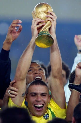 Ronaldo Nazario looks at his 2002 FIFA World Cup winners trophy