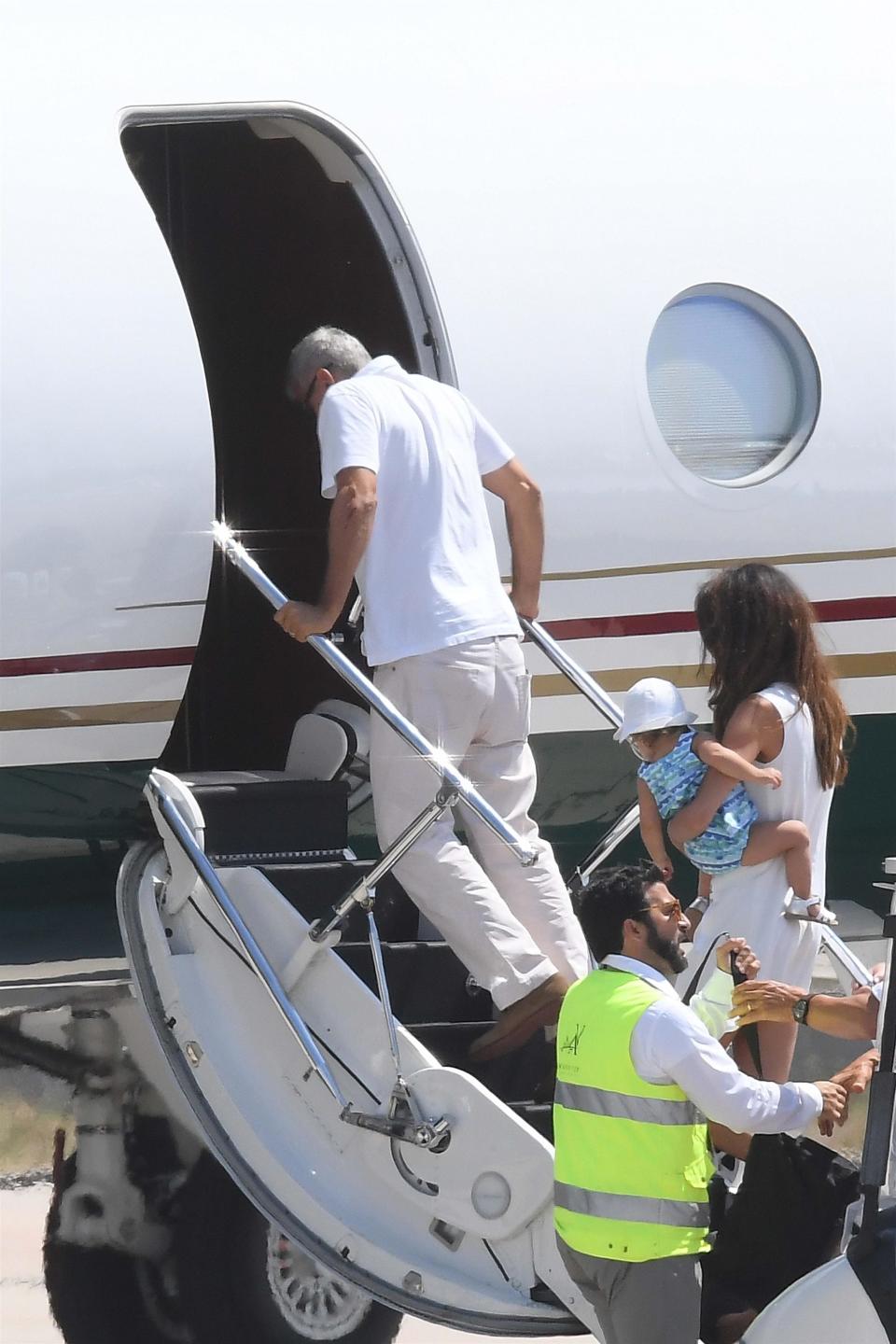 George Clooney boarding a plane to leave Sardinia on July 12 following his motorbike crash. His elbow appeared to have bruises and cuts on it, though it’s unclear if they were related to the crash. Source: BackGrid