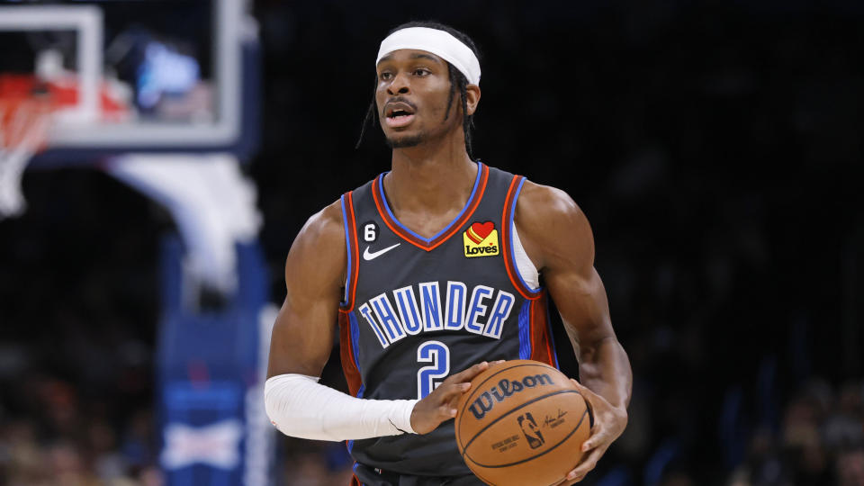 Oklahoma City Thunder guard Shai Gilgeous-Alexander holds the ball during the second half of an NBA basketball game against the Cleveland Cavaliers Friday, Jan. 27, 2023, in Oklahoma City. (AP Photo/Nate Billings)