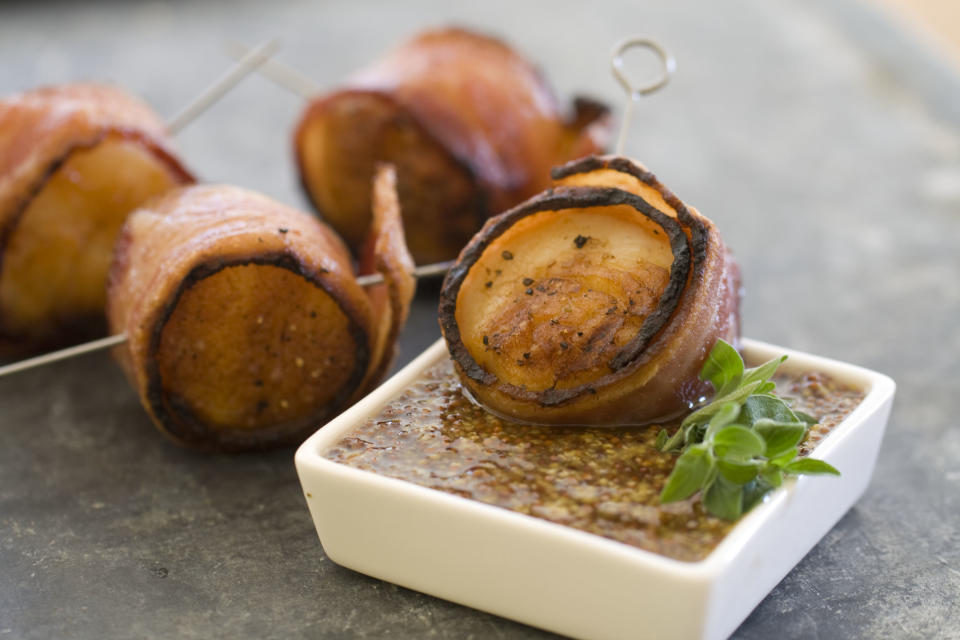 This Nov 4, 2013 photo shows grilled bacon wrapped scallops in Concord, N.H. This all-protein finger food appetizer is perfect for holiday entertaining. (AP Photo/Matthew Mead)