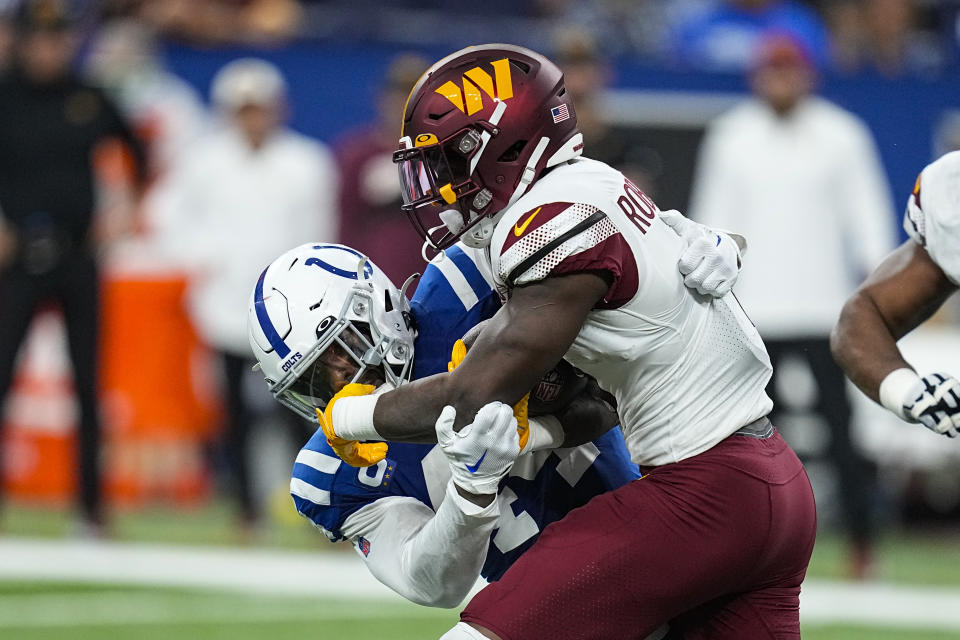 Indianapolis Colts linebacker Zaire Franklin (44) tackles Washington Commanders running back Brian Robinson Jr. (8) in the first half of an NFL football game in Indianapolis, Sunday, Oct. 30, 2022. (AP Photo/Darron Cummings)