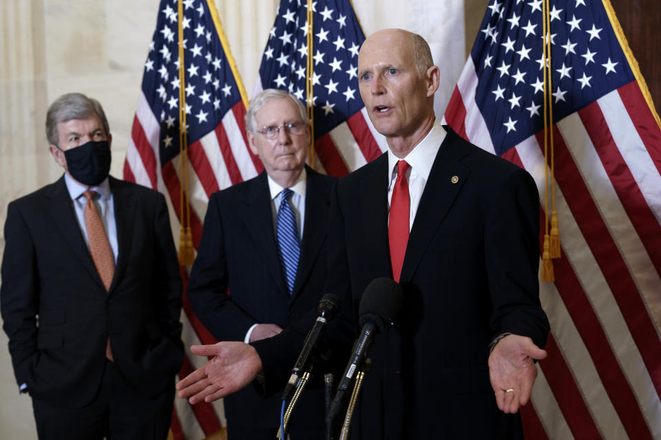 FILE - In this Nov. 10, 2020, file photo Sen. Rick Scott, R-Fla., joined at center by Senate Majority Leader Mitch McConnell, R-Ky., and Sen. Roy Blunt, R-Mo., far left, speaks to reporters briefly following a closed-door meeting where the Republican Conference held leadership elections, on Capitol Hill in Washington. (AP Photo/J. Scott Applewhite, File)