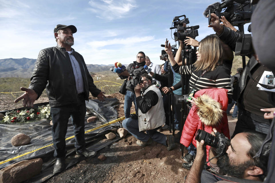 Adrian LeBaron speaks to reporters in the place where one of the cars belonging to the extended LeBaron family was ambushed by gunmen last year near Bavispe, Sonora state, Mexico, Sunday Jan. 12, 2020. Lopez Obrador said Sunday there is an agreement to establish a monument will be put up to memorialize nine U.S.-Mexican dual citizens ambushed and slain last year by drug gang assassins along a remote road near New Mexico. (AP Photo/Christian Chavez)