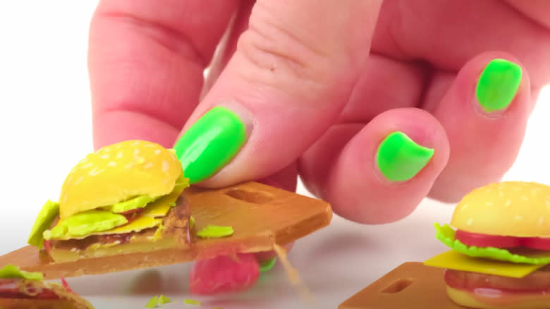 mini cake burger in hand