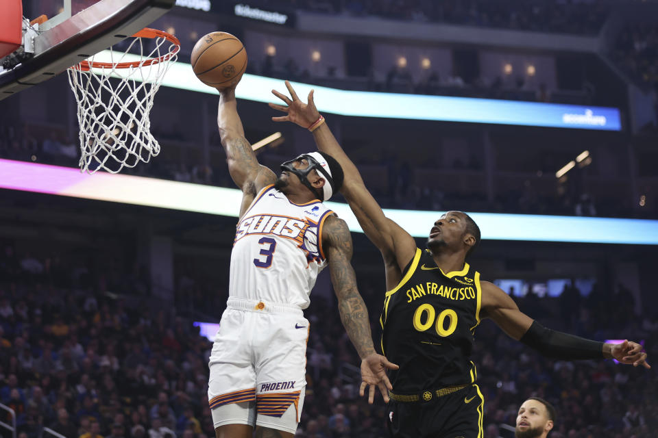 Phoenix Suns guard Bradley Beal (3) shoots against Golden State Warriors forward Jonathan Kuminga (00) during the first half of an NBA basketball game in San Francisco, Saturday, Feb. 10, 2024. (AP Photo/Jed Jacobsohn)