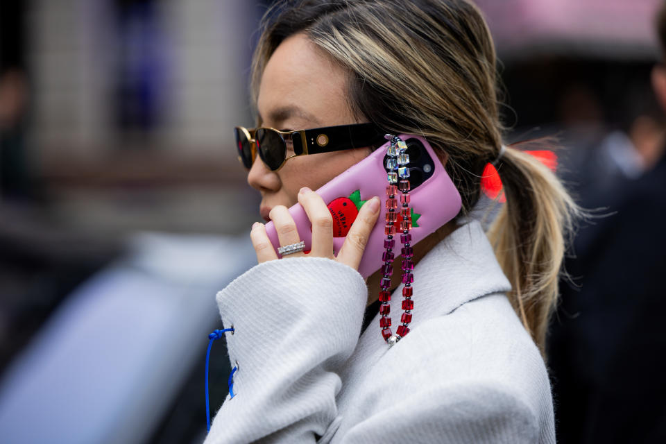 LONDON, ENGLAND – FEBRUARY 17: A guest wearing a white and pink Apple iPhone case and necklace in front of Erdem during London Fashion Week February 2024 on February 17, 2024 in London, England. (Photo by Christian Vierig/Getty Images)