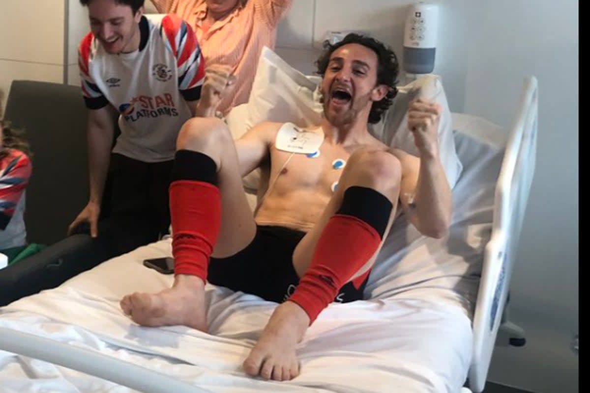 Tom Lockyer’s dad posted a picture on social media of his son celebrating promotion from his hospital bed  (Twitter/@sl_cardiff)