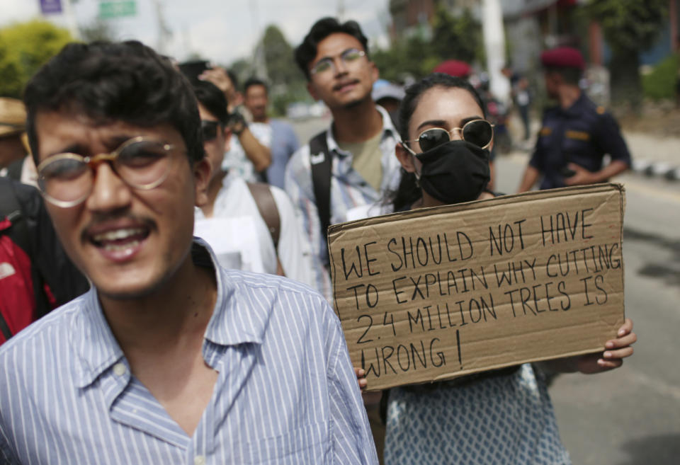 Nepalese activists shout slogans during a protest outside Civil Aviation Authority of Nepal, in Kathmandu, Monday, Aug. 19, 2019. A small group of protesters demonstrated in Nepal's capital against plans to cut down millions of trees for an international airport in the southern part of the country. (AP Photo/Niranjan Shrestha)