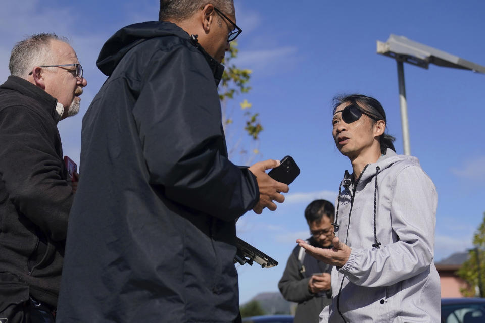 FILE - Kaiyu Zhang speaks with reporters about being assaulted by a group of young men wearing red headbands or red bands on their arms, during a news conference in San Francisco, Wednesday, Nov. 29, 2023. A congressional commission will ask the Justice Department to investigate the role of the Chinese government after a group of anti-Beijing protesters claimed they were beaten and harassed by Beijing’s agents in November in San Francisco during an official visit by Chinese President Xi Jinping. The Chinese embassy has denied any involvement but said people had “voluntarily” travelled to San Francisco to welcome Xi. (AP Photo/Jeff Chiu, File)