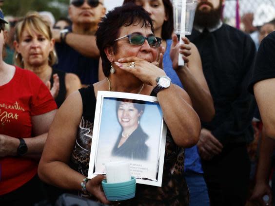 Lupe Lopez carries a photo of Elsa Mendoza Marquez, a Mexican schoolteacher from across the US border who was killed in the El Paso shooting (Getty Images)