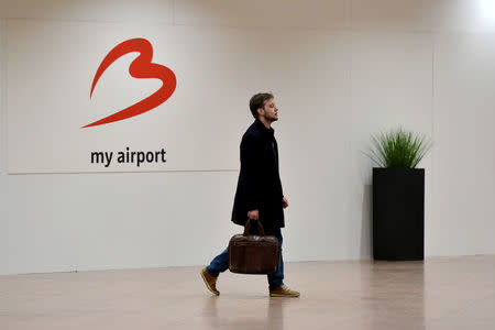 A traveller walks in the departure hall after a ceremony at Brussels Airport as it reopens 40 days after deadly attacks in Zaventem, Belgium, May 1, 2016. REUTERS/Eric Vidal