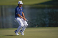 Collin Morikawa reacts to his putt on the 13th green during their foursomes match at the Presidents Cup golf tournament at the Quail Hollow Club, Saturday, Sept. 24, 2022, in Charlotte, N.C. (AP Photo/Julio Cortez)