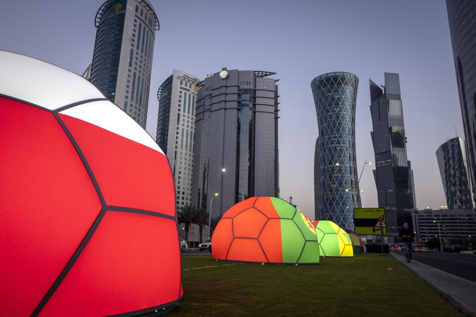 FILE - Domes featuring different national colors are displayed near the Doha Exhibition and Convention Center where soccer World Cup draw will be held, in Doha, Qatar, Thursday, March 31, 2022. Qatar's residents squeezed as World Cup rental demand soars. (AP Photo/Darko Bandic, File)