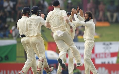 England bowler Moeen Ali and team mates celebrate after the bowler had taken the wicket of Matthews after a review - Credit: Getty Images