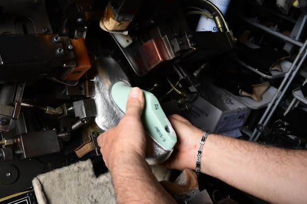 A worker lasts the upper of a shoe at the Valbrenta Shoe Factory, which uses traditional techniques to make prototypes from stitch to finish. 