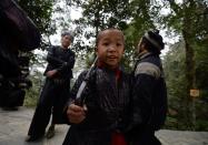 Young members of the Miao minority group carrying replica guns in Biasha Village, Guizhou Province on February 4, 2014