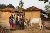 Munni Kol, 70, in white, with his son Bishambar Kol, daughters-in-law, Asha and Manju, and his grandchildren pose for a photograph in front of their home, in Jamsoti village, Uttar Pradesh state, India, on June 8, 2021. Kol got himself vaccinated against the coronavirus, where as his family has refused to. India's vaccination efforts are being undermined by widespread hesitancy and fear of the jabs, fueled by misinformation and mistrust. That's especially true in rural India, where two-thirds of the country’s nearly 1.4 billion people live. (AP Photo/Rajesh Kumar Singh)