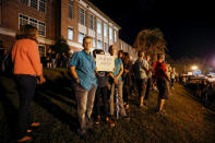 Parents and students wait for busses carrying students from Marjory Stoneman Douglas High School to arrive at Leon High School, prior to their meetings the next day with Florida state legislators, following last week's mass shooting on their campus, in Tallahassee, Florida, U.S., February 20, 2018. REUTERS/Colin Hackley