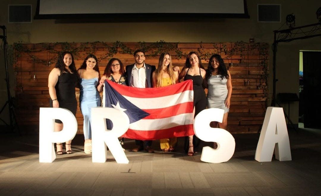 Students of the Puerto Rican Student Association pose for a picture on Florida State University's campus during an event.