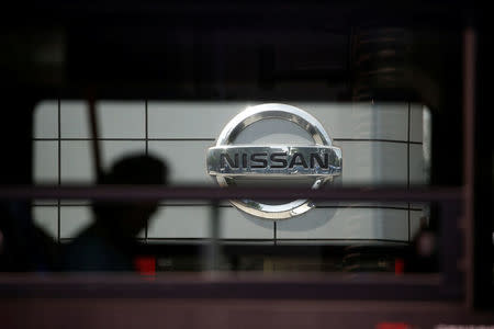 The logo of Nissan is seen through a window of a bus passing by its dealership in Seoul, South Korea, May 16, 2016. REUTERS/Kim Hong-Ji