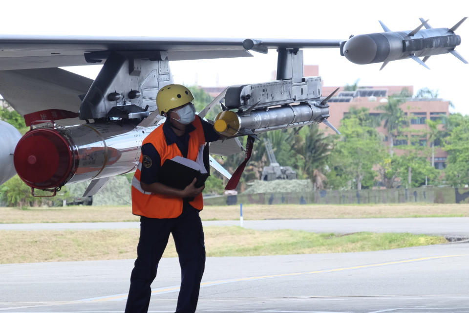 A military personnel inspects a load a AIM-9 sidewinder air-to-air missile next to Harpoon A-84, anti-ship missile on a F16V fighter jet at the Hualien Airbase in Taiwan's southeastern Hualien county on Wednesday, Aug. 17, 2022. Taiwan is staging military exercises to show its ability to resist Chinese pressure to accept Beijing's political control over the island. (AP Photo/Johnson Lai)