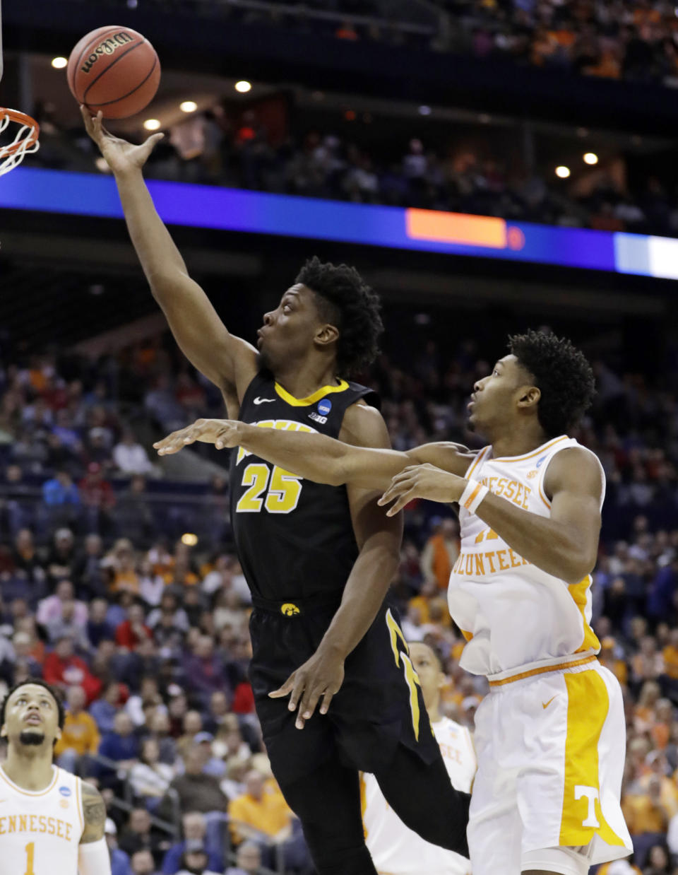 Iowa's Tyler Cook (25) drives to the basket against Tennessee's Kyle Alexander (11) in the second half during a second round men's college basketball game in the NCAA Tournament in Columbus, Ohio, Sunday, March 24, 2019. Tennessee won 83-77 in overtime. (AP Photo/Tony Dejak)