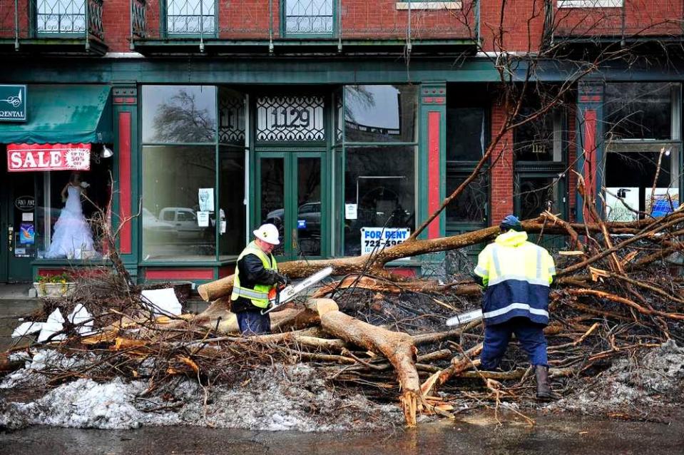 FILE - Workers from the City of Augusta clear a tree on Broad Street downtown that fell during the Feb. 11, 2014, ice storm. This year will mark 10 years since it happened.