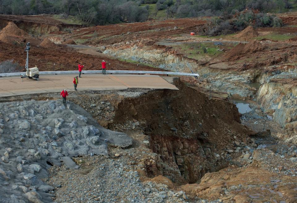 California Department of Water Resources crews inspect and evaluate the erosion just below the Lake Oroville Emergency Spillway site after lake levels receded, in Oroville, California, U.S., February 13, 2017. (Kelly M. Grow/ California Department of Water Resources/Handout via Reuters)