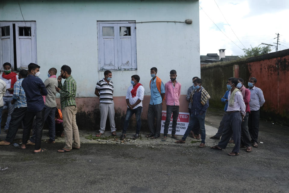 Migrant workers wait to give their samples to test for COVID-19 in Kohima, capital of the northeastern Indian state of Nagaland, Saturday, Oct. 10, 2020. India’s total coronavirus positive cases near 7 million with another 73,272 infections reported in the past 24 hours. The Health Ministry on Saturday put the total positive caseload at 6.97 million, second to 7.66 million infections registered in the worst-hit United States. (AP Photo/Yirmiyan Arthur)