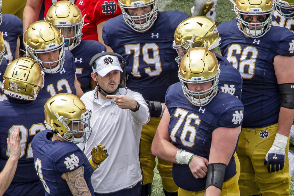 FILE - In this May 1, 2021, file photo, Notre Dame offensive coordinator Tommy Rees talks with players during a timeout in the Blue-Gold NCAA spring football game in South Bend, Ind. The 2021 challenge for Rees is to improve considerably from last season’s scoring output of 33.4 points per game. (AP Photo/Robert Franklin, File)