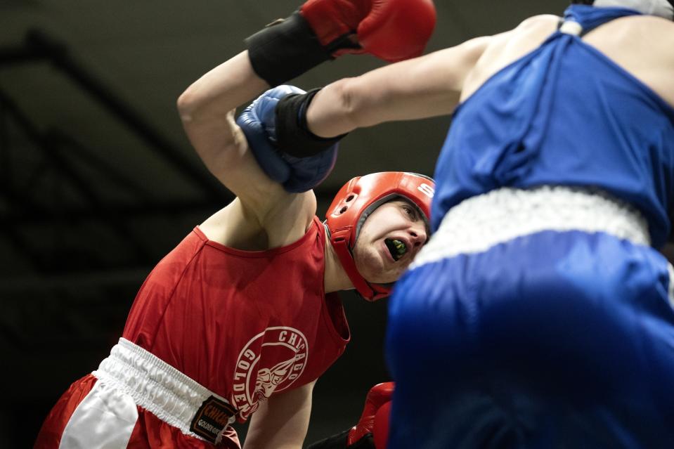 Claire Quinn, left, battles Stacey Parker in the 156-pound championship match on the final night of the 100th year of the Chicago Golden Gloves boxing tournament Sunday, April 16, 2023, in Cicero, Ill. Quinn lost by split decision. (AP Photo/Erin Hooley)