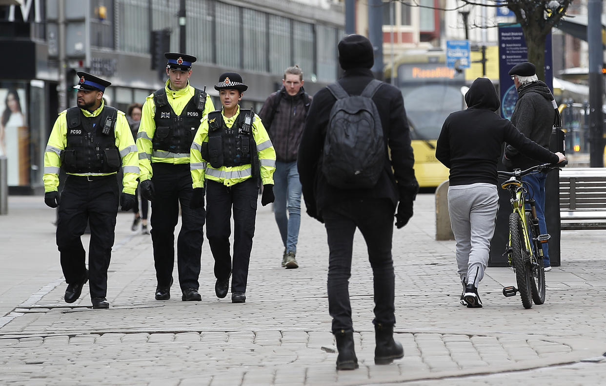 Police officers walk down Market Street, Manchester as the UK continues in lockdown to help curb the spread of the coronavirus. (Photo by Martin Rickett/PA Images via Getty Images)