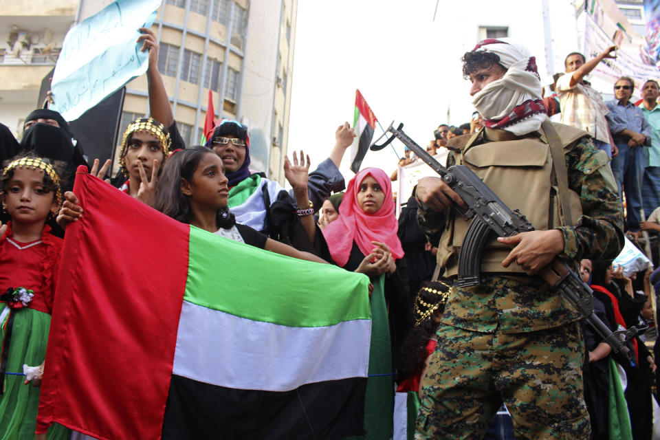 FILE - In this Sept. 5, 2019 file photo, a girl holds the flag of the United Arab Emirates during a rally of supporters of southern separatists to show support for the UAE amid a standoff with the internationally recognized government, in Aden, Yemen. Human Rights Watch warned Monday, Sept. 14, 2020 that warring parties in Yemen's yearslong conflict are “severely restricting” the delivery of desperately needed aid as the country slides toward famine amid the coronavirus pandemic. (AP Photo/Wail al-Qubaty, File)