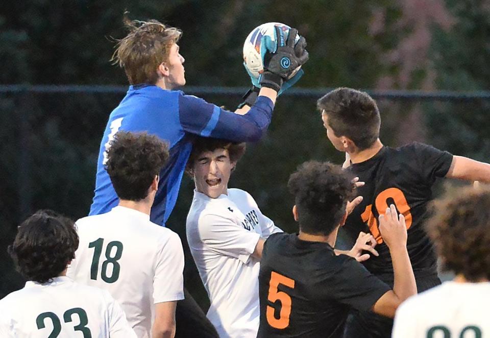 Mercyhurst Prep senior goalkeeper Landon Spero, top, makes a stop against Harbor Creek during a PIAA District 10 Class 2A boys soccer quarterfinal at Dollinger Field, Hagerty Family Events Center, in Erie on Oct. 24, 2023.