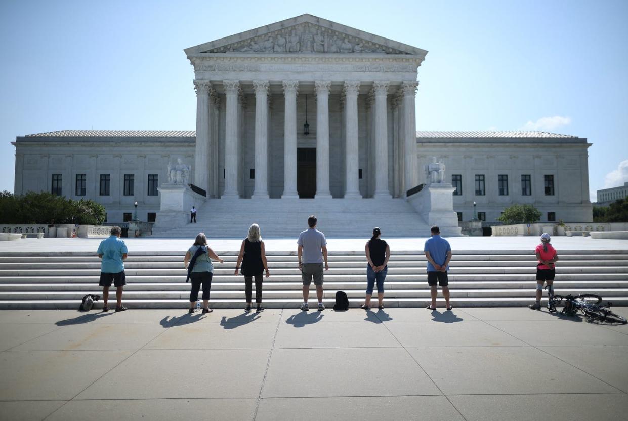 <span class="caption">Anti-abortion demonstrators pray outside the Supreme Court building on July 8, 2020, while they wait for a ruling.</span> <span class="attribution"><a class="link " href="https://www.gettyimages.com/detail/news-photo/anti-abortion-demonstrators-pray-in-front-of-the-u-s-news-photo/1255027472" rel="nofollow noopener" target="_blank" data-ylk="slk:Chip Somodevilla/Getty Images;elm:context_link;itc:0;sec:content-canvas">Chip Somodevilla/Getty Images</a></span>