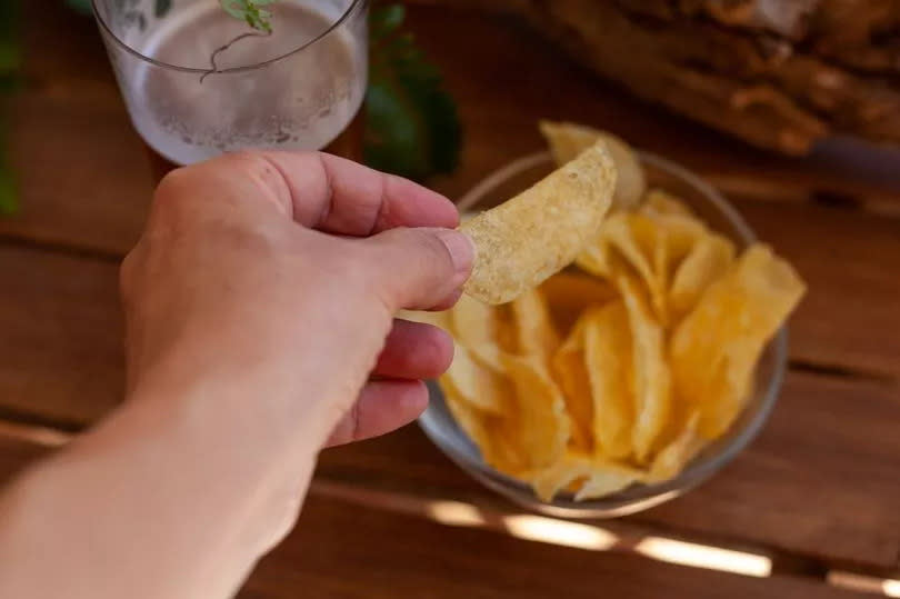 Person holding a crisp