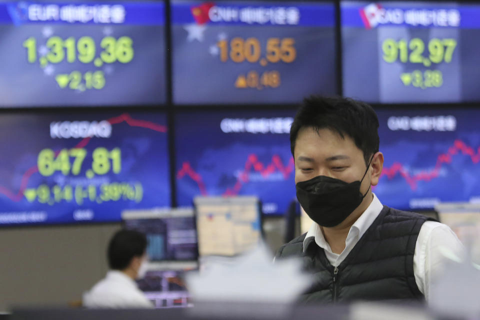 A currency trader watches monitors at the foreign exchange dealing room of the KEB Hana Bank headquarters in Seoul, South Korea, Wednesday, Feb. 26, 2020. Asian shares slid Wednesday following another sharp fall on Wall Street as fears spread that the growing virus outbreak will put the brakes on the global economy.(AP Photo/Ahn Young-joon)