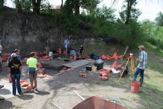 Visitors on a guided tour watch excavation in progress at one of the excavation areas at the Lubbock Lake Landmark.