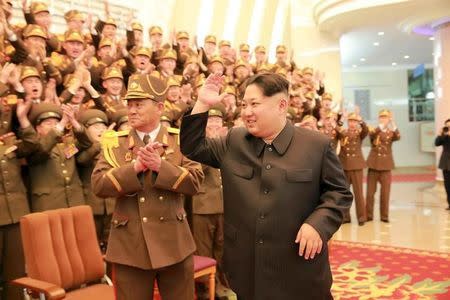 North Korean leader Kim Jong Un (R) waves during a concert marking the 70th founding anniversary of the Korean People's Army (KPA) military band in this undated photo released by North Korea's Korean Central News Agency (KCNA) in Pyongyang February 23, 2016. REUTERS/KCNA