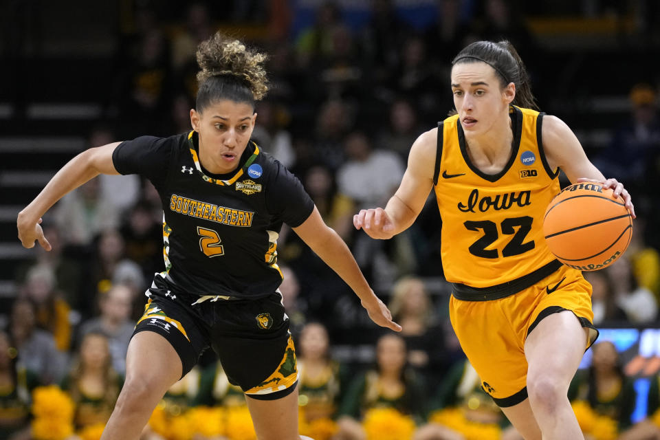 Iowa guard Caitlin Clark (22) drives up court past Southeastern Louisiana guard Cierria Cunningham (2) in the second half of a first-round college basketball game in the NCAA Tournament, Friday, March 17, 2023, in Iowa City, Iowa. Iowa won 95-43. (AP Photo/Charlie Neibergall)