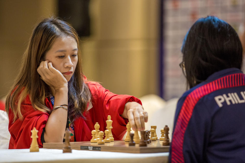 Singapore chess player Gong Qianyun playing against Philippines' Shania Mae Mendoza en route to her SEA Games gold medal. (PHOTO: Sport Singapore/Dyan Tjhia)