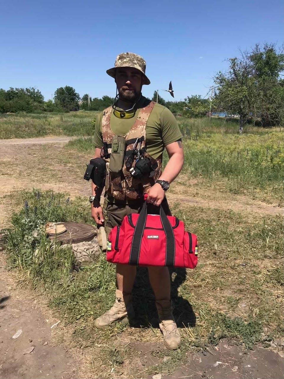 A field medic in Ukraine sometime around the first week of June 2022 — most likely somewhere near Kharkiv, Luhansk or Mykolaiv — holds a trauma bag donated by Mary Greeley Medical Center in Ames. The hospital donated 20 such bags for first responders to Iowa Sister States, which had the bags packed in with a large shipment of meals bound for Cherkasy, Ukraine, from West Des Moines-based Meals from the Heartland.