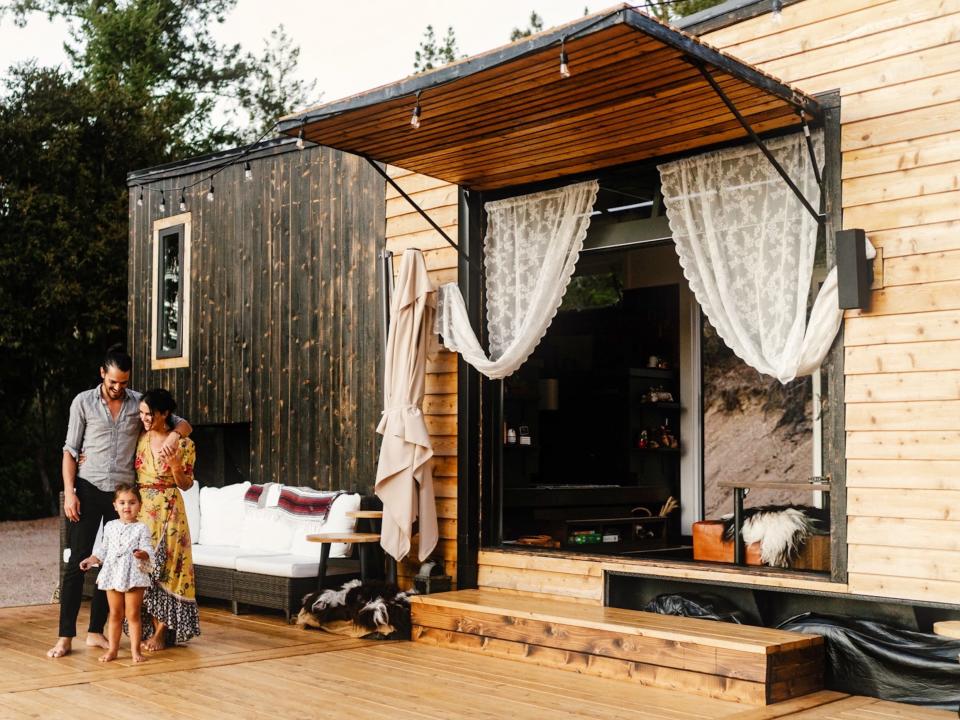 Ryan Tuttle and family standing outside their tiny house